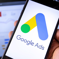 The Google Ads logo on a phone, representing paid ad campaigns that teams can use as a sports fundraising idea.